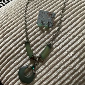 Green sandglass inspired necklace with green stone.  Stainless steel
